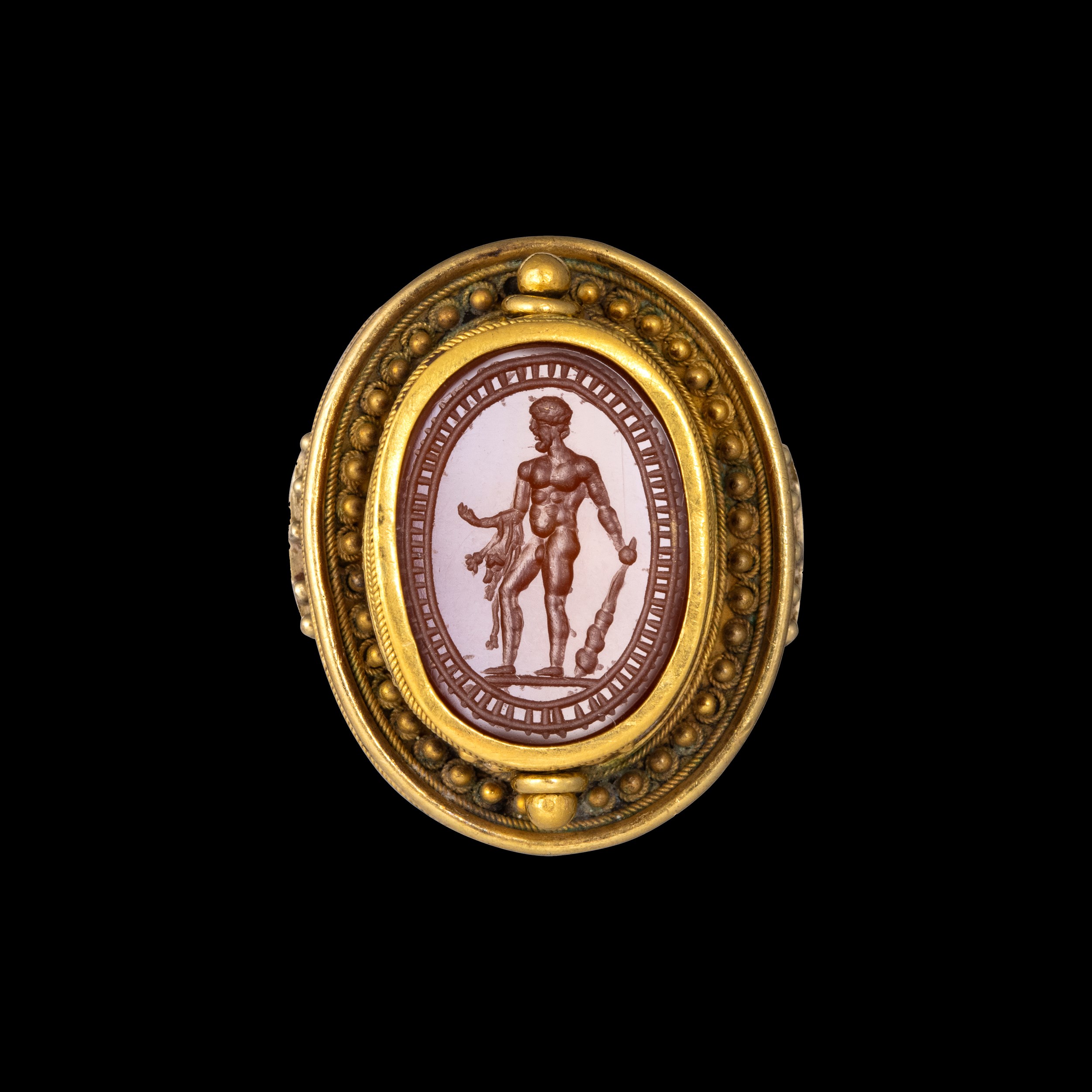 An  Etruscan Revival gold ring set with a swivel carnelian  scarab. Hercules. 